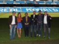 Real Madrid supporters posing on the field.