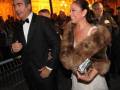 Celebrity couple attending an event in formal attire.