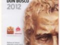 Buste de bronce de Don Bosco con una imagen de familia en la base. Texto en español sobre la peregrinación de la reliquia de Don Bosco en 2012.