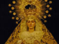 Imagen de una Virgen con vestimentas doradas y un halo estrellado.